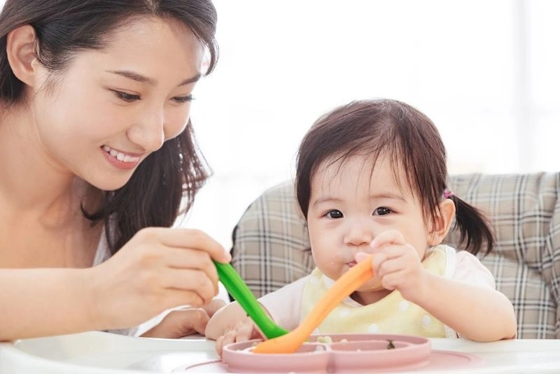 Giải đáp dạy trẻ 14 tháng tuổi những gì đó là dạy con cầm thìa xúc đồ ăn